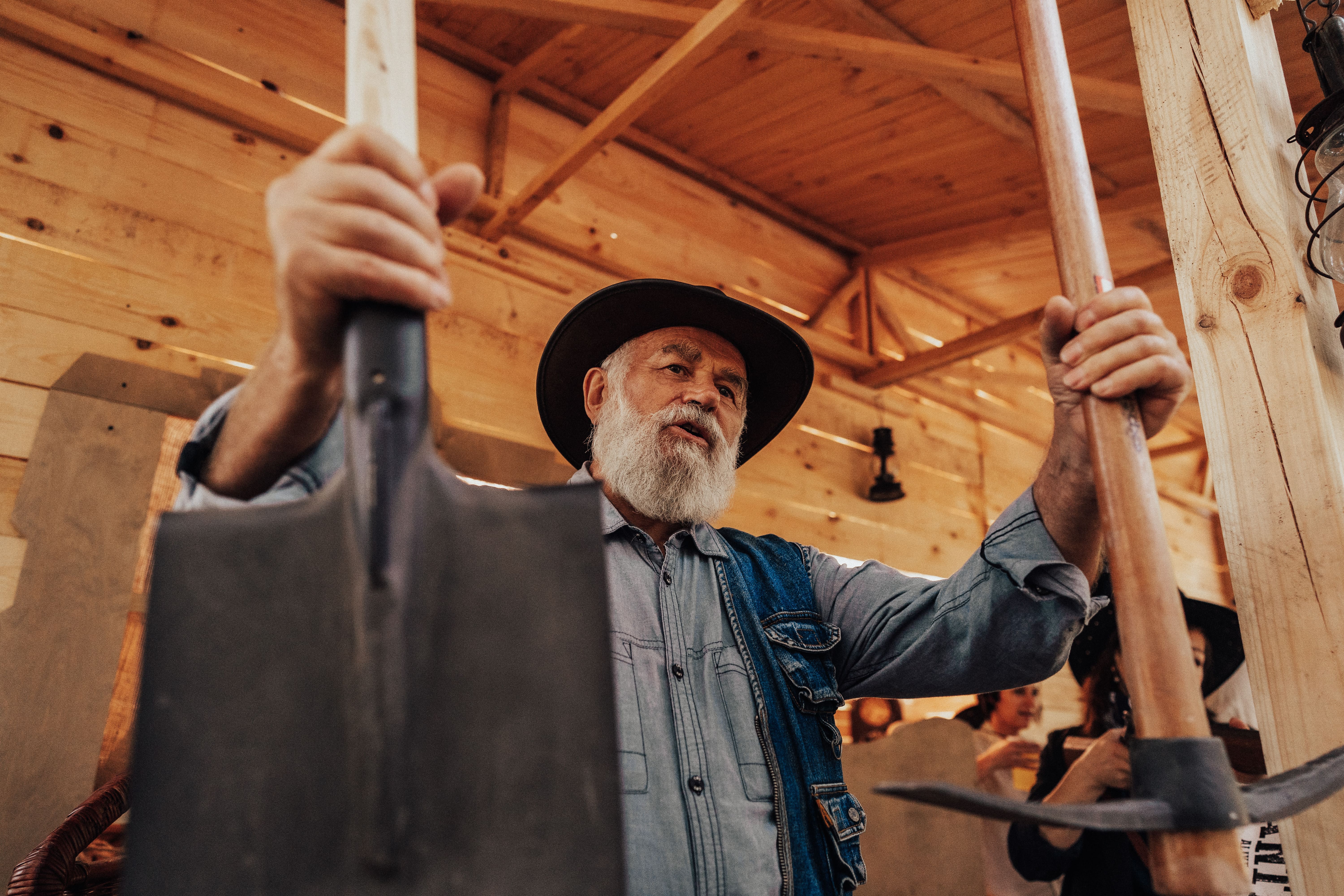 cowboy holds shovel and pick